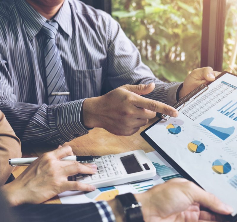 Co working conference Business team meeting present investor colleagues discussing new plan financial graph data on office table with laptop and digital tablet Finance accounting investment.